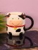Кружка керамическая iLikeGift "Круглая корова", черная, 410мл
